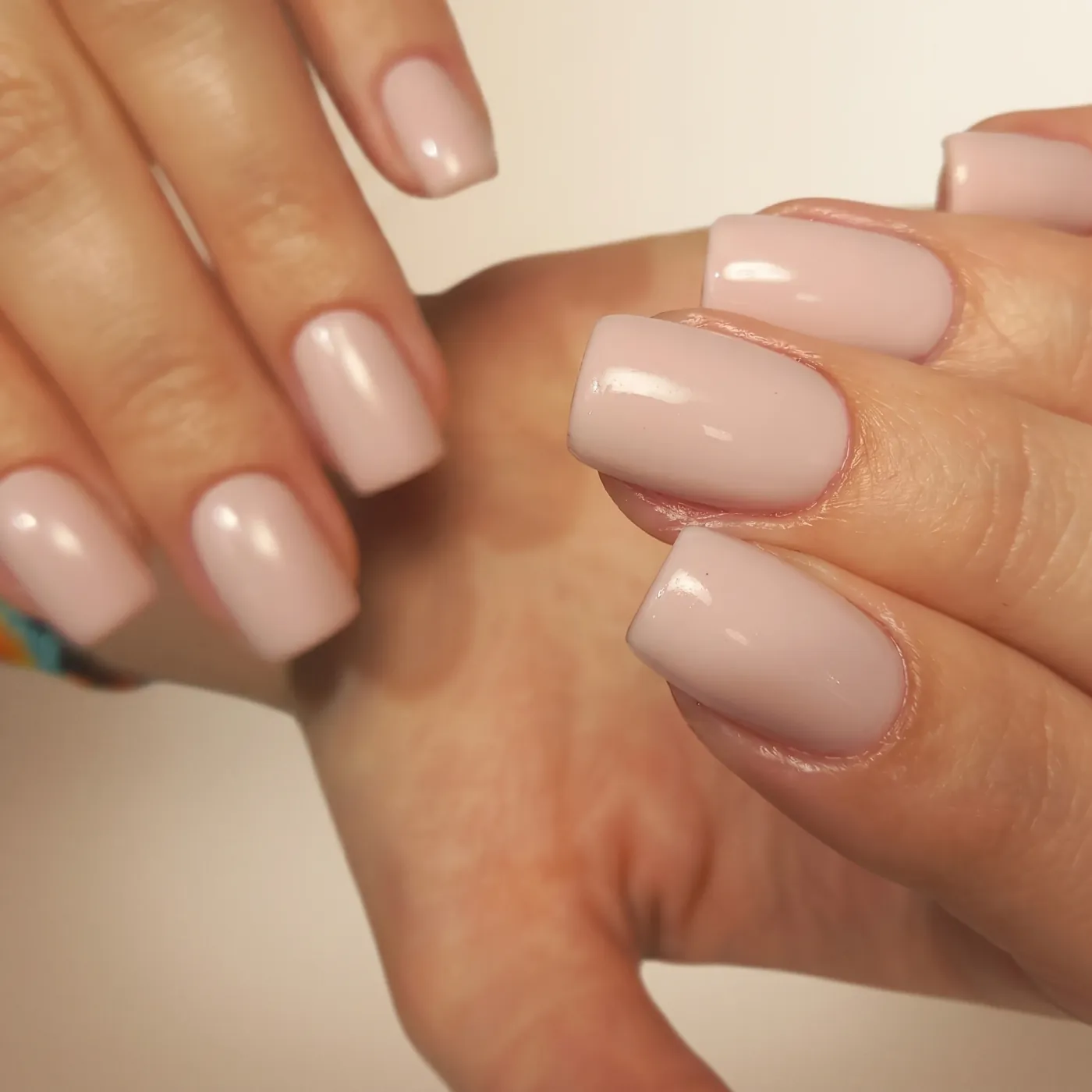 Heldekkende lys rosa nude gellak med perlemorskimmer på middels lange kvadratiske negler